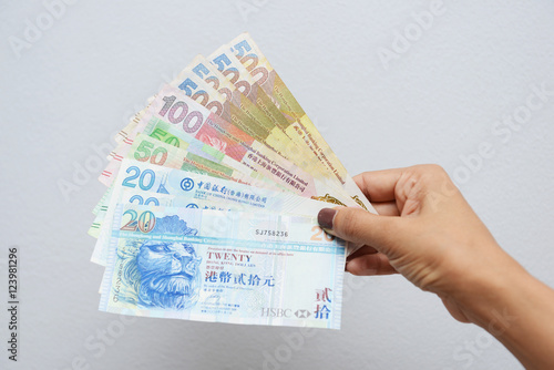 hand with Hong Kong dollar bills