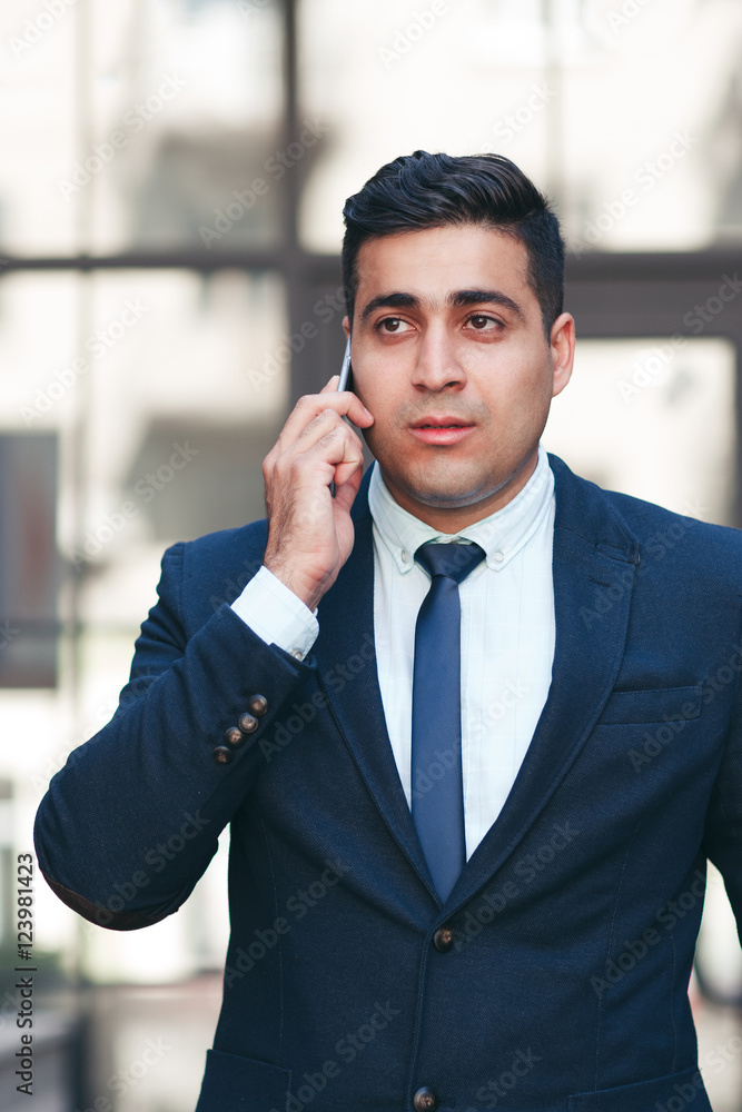 Young man talking on the mobile phone. Communication and telecommunication concept. Young man talking on the mobile phone. Communication and telecommunication concept.