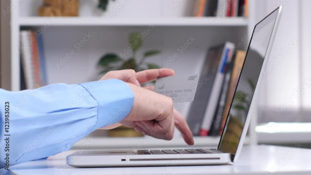 Man doing online shopping via silver card. Close up Man doing online shopping via silver card. Close up