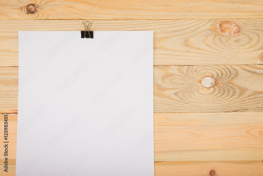 Black clip and White blank note paper hang on wood pane Black clip and White blank note paper hang on wood pane
