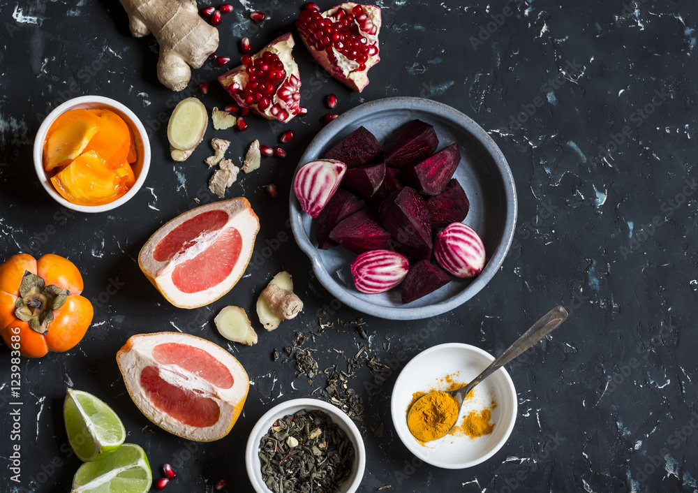 Ingredients for cooking beet and ginger detox elixir. On a dark background, top view Ingredients for cooking beet and ginger detox elixir. On a dark background, top view