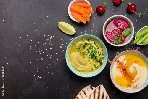 Various vegetarian colorful dips with pita bread
