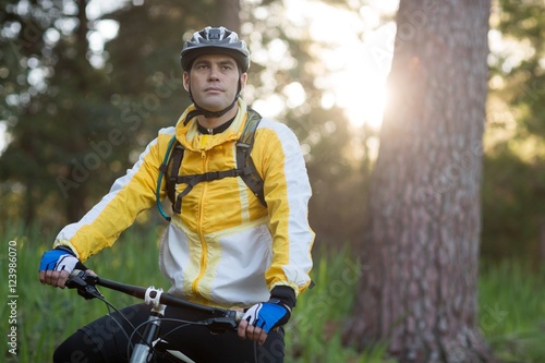 Male biker with mountain bike in forest