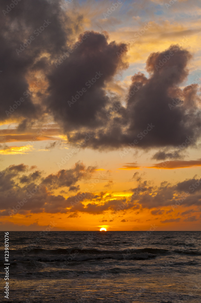 A colorful sunset on the horizon with dense clouds, Kapiti coast, north island, New Zealand