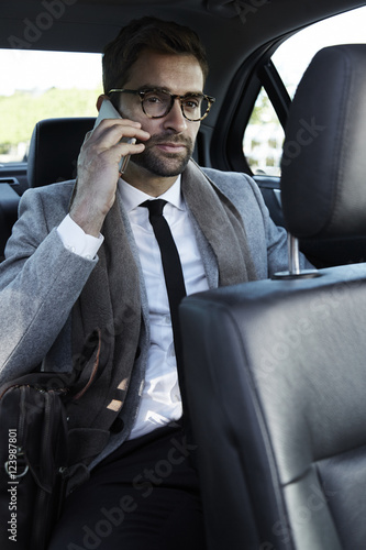 Businessman making call in car © sanneberg