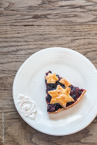 Portion of mince pie on the wooden background