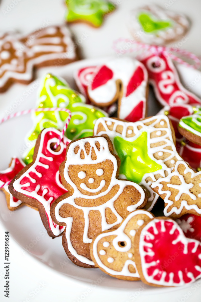 Different Christmas cookies on a plate on a white background