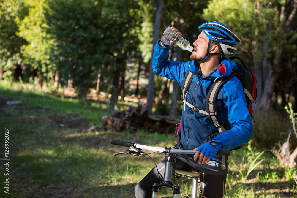 Male mountain biker drinking water Male mountain biker drinking water