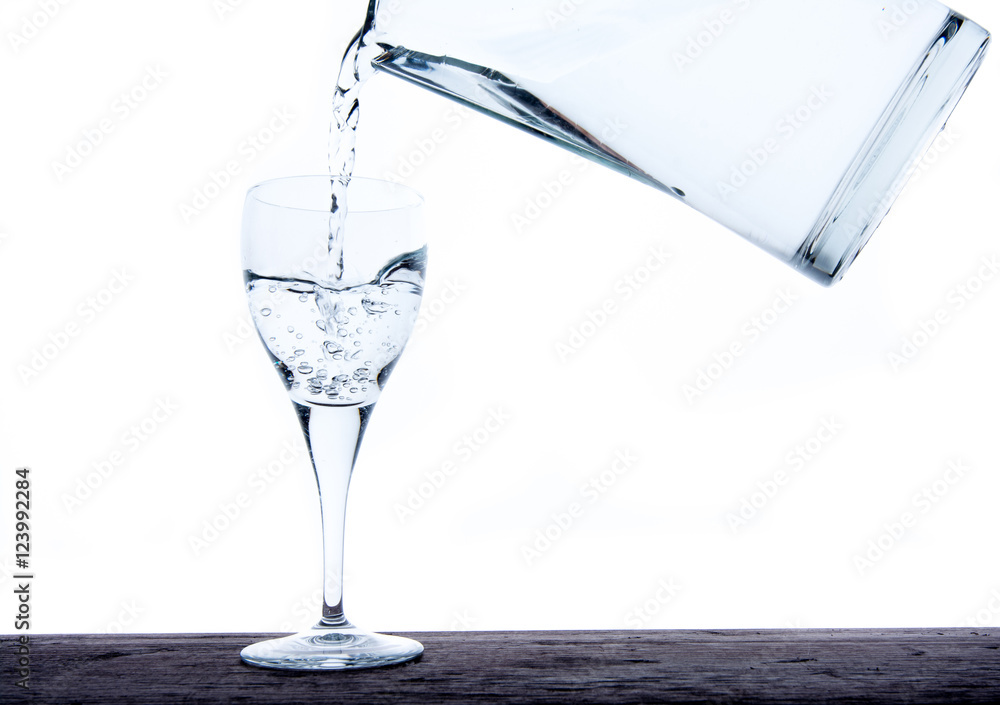 Filling glass with water from jug Filling glass with water from jug
