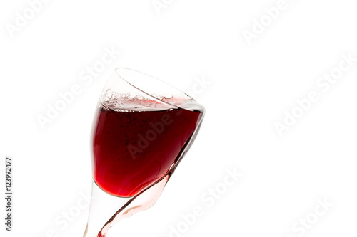 a glass of red wine on white background, isolated in backlight