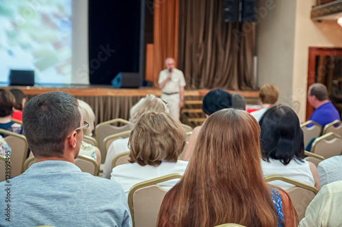 The audience listens to the acting in a conference hall