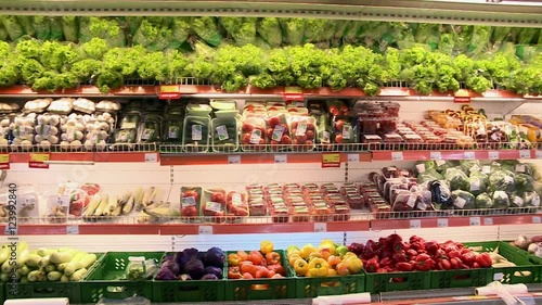Fresh vegetables on the shelves of the supermarket.Colorful vegetables and herbs.