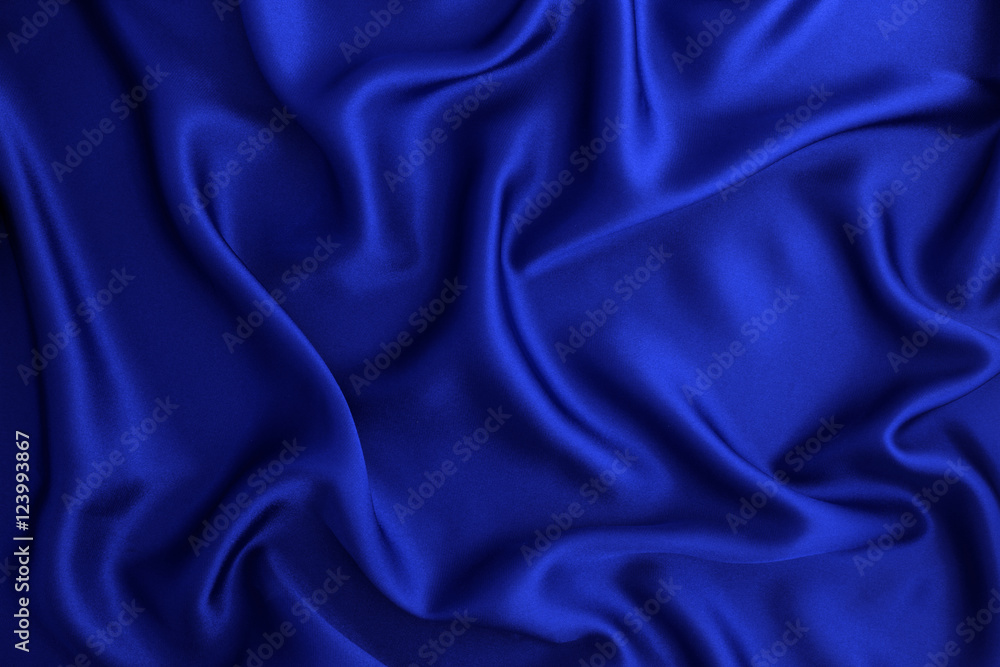 Close up wave luxury blue silk or satin fabric background Close up wave luxury blue silk or satin fabric background