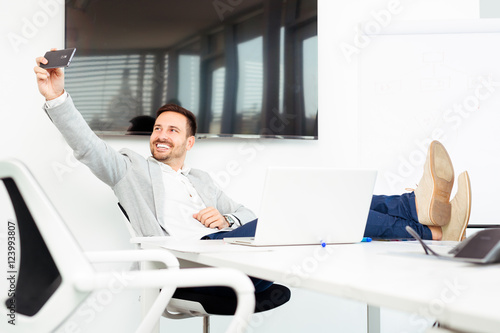 Happy young business man work in modern office