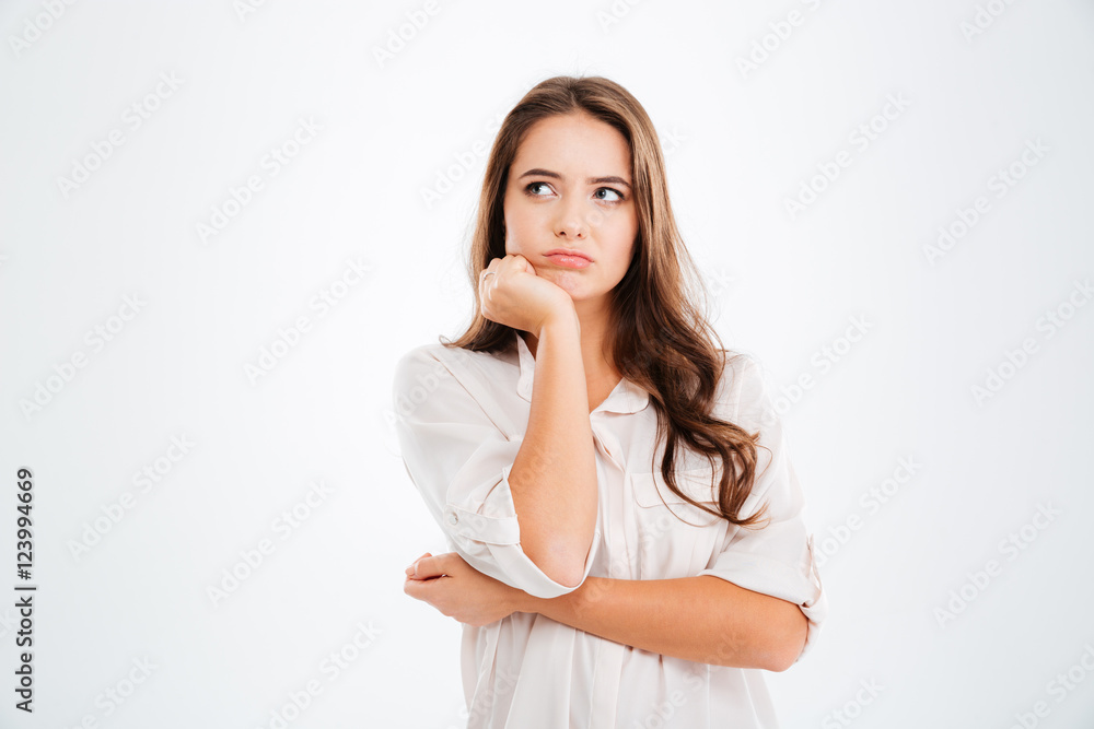 Thoughtful cute young woman standing and thinking Thoughtful cute young woman standing and thinking
