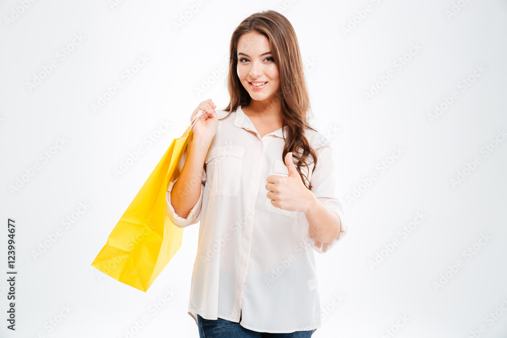 Happy woman holding shopping bags and showing thumb up Happy woman holding shopping bags and showing thumb up