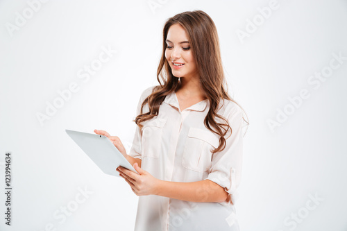 Smiling beautiful woman using tablet computer