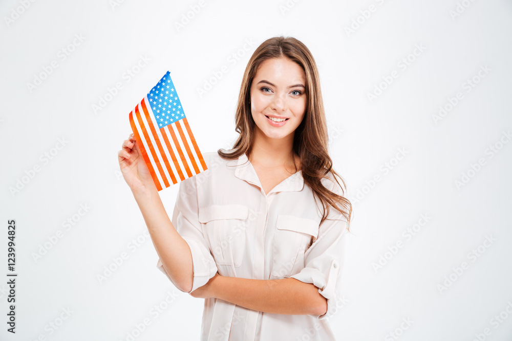 Woman holding USA flag and looking at camera Woman holding USA flag and looking at camera