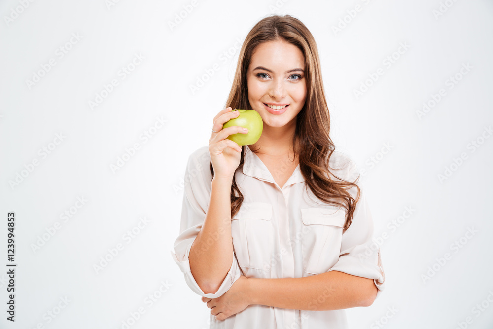 Portrait of a happy young girl holding green apple Portrait of a happy young girl holding green apple