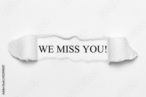 We miss you! on white torn paper photo
