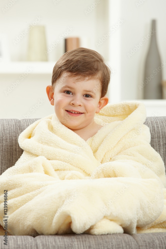 Portrait of happy kid sitting in oversize bathrobe Portrait of happy kid sitting in oversize bathrobe