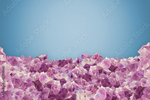 Pieces of natural amethyst over blue vanilla background