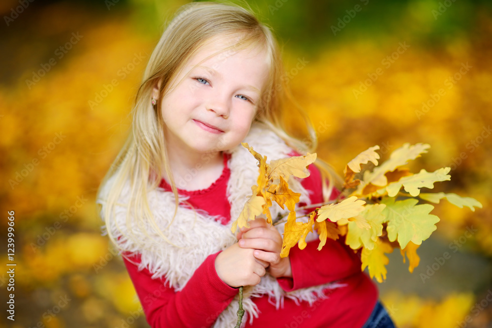 Cute little girl having fun on beautiful autumn day Cute little girl having fun on beautiful autumn day
