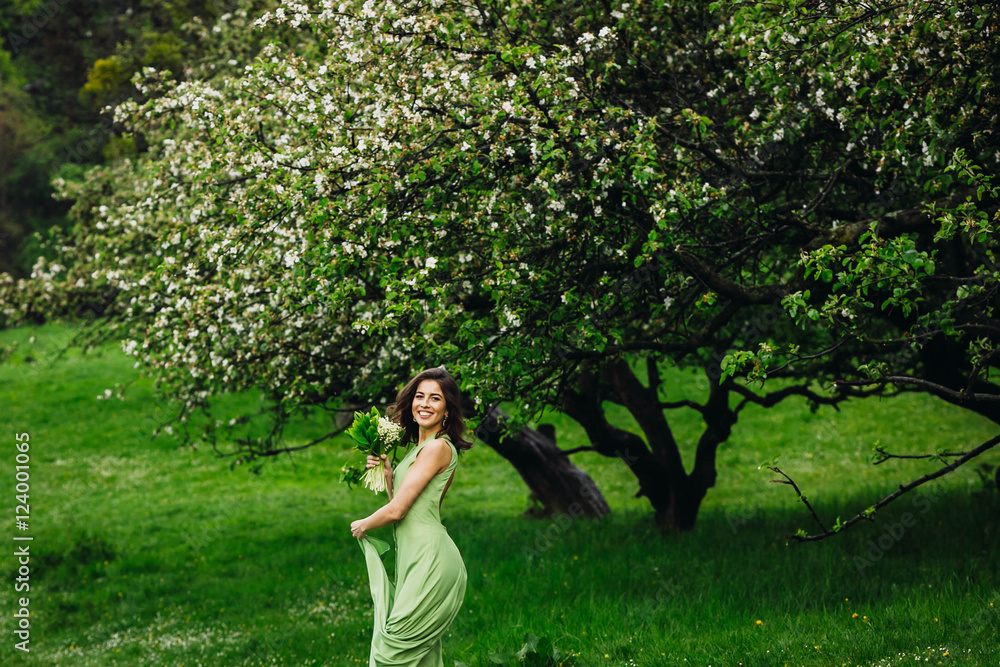 beautiful young woman walking in a green garden beautiful young woman walking in a green garden