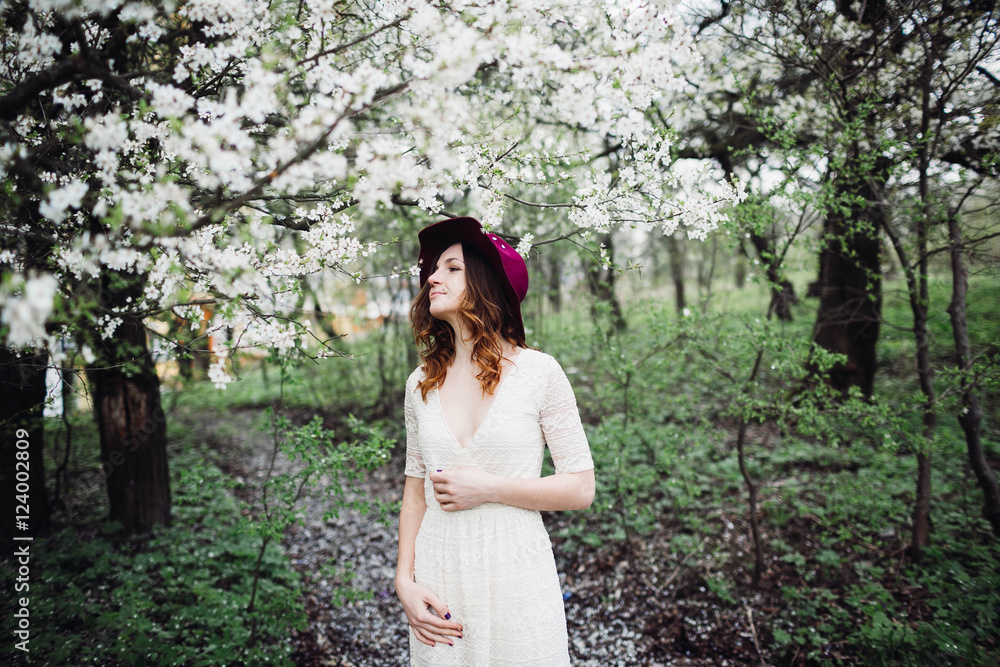 beautiful young woman standing near blooming tree beautiful young woman standing near blooming tree