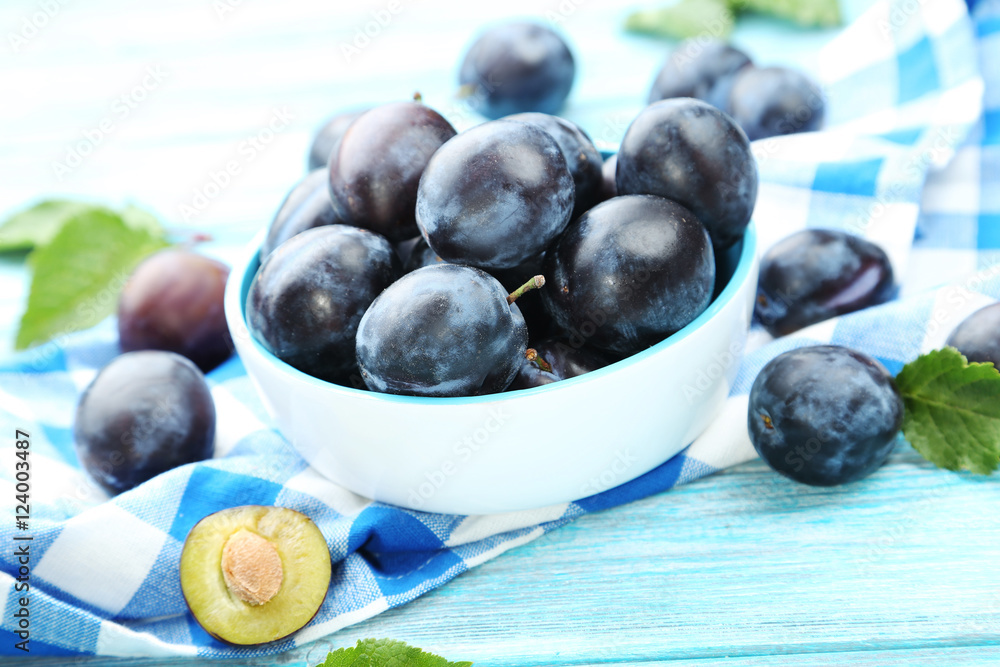 Tasty and ripe plums on blue wooden table Tasty and ripe plums on blue wooden table