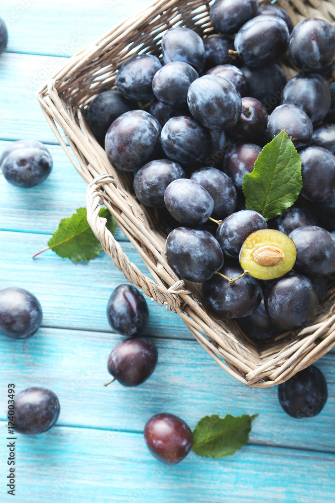 Tasty and ripe plums on blue wooden table Tasty and ripe plums on blue wooden table