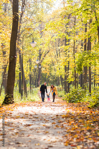 Lovely family walking in the autumn forest. Healthy lifestyle