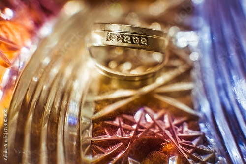 A blurred picture of wedding rings lying on the golden tray