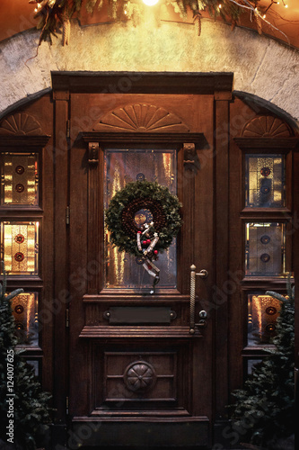 christmas wreath on wooden door. luxury decorated store front wi