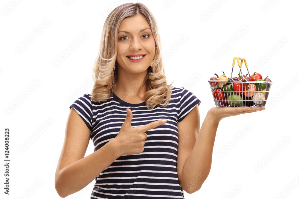 Woman holding a small shopping basket and pointing Woman holding a small shopping basket and pointing