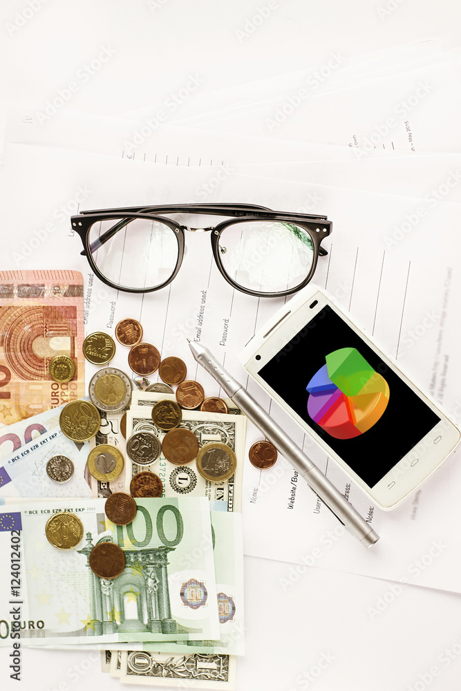 money phone calculator pen paper and glasses on white background money phone calculator pen paper and glasses on white background