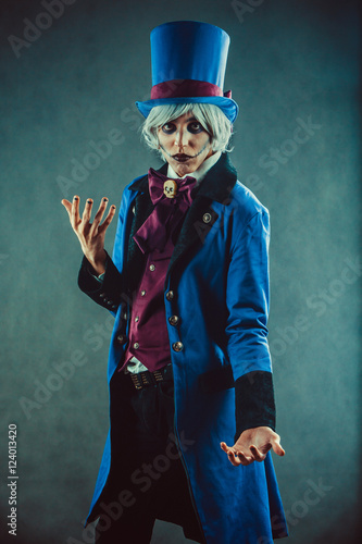 Sad gesticulating circus actor in blue tuxedo.