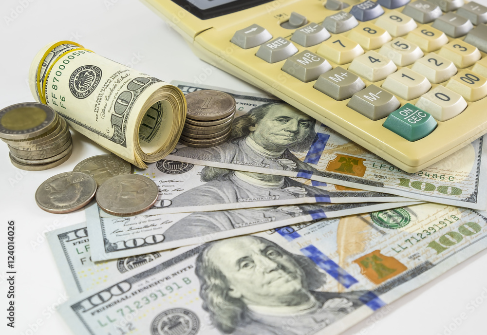 Fototapeta premium 100 US dollars bank notes and money coins. with computer keyboar