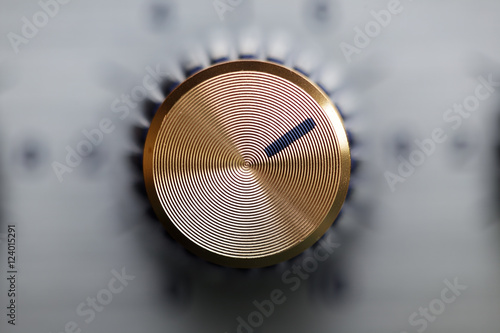 close up of golden knob guitar amplifier photo