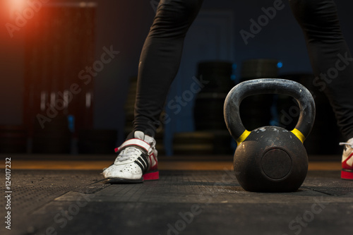 Man preparing for exercises with kettlebell.