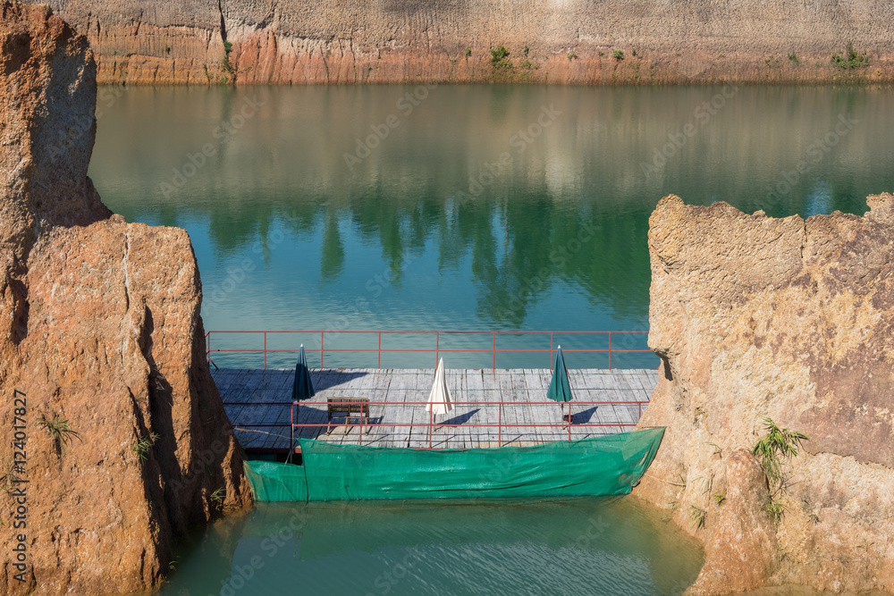 Floating terrace in lake among rocky canyon