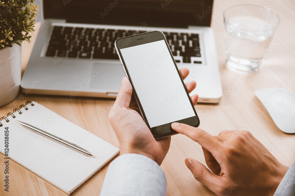 Businessman hand holding a phone with isolated screen over the d Businessman hand holding a phone with isolated screen over the d