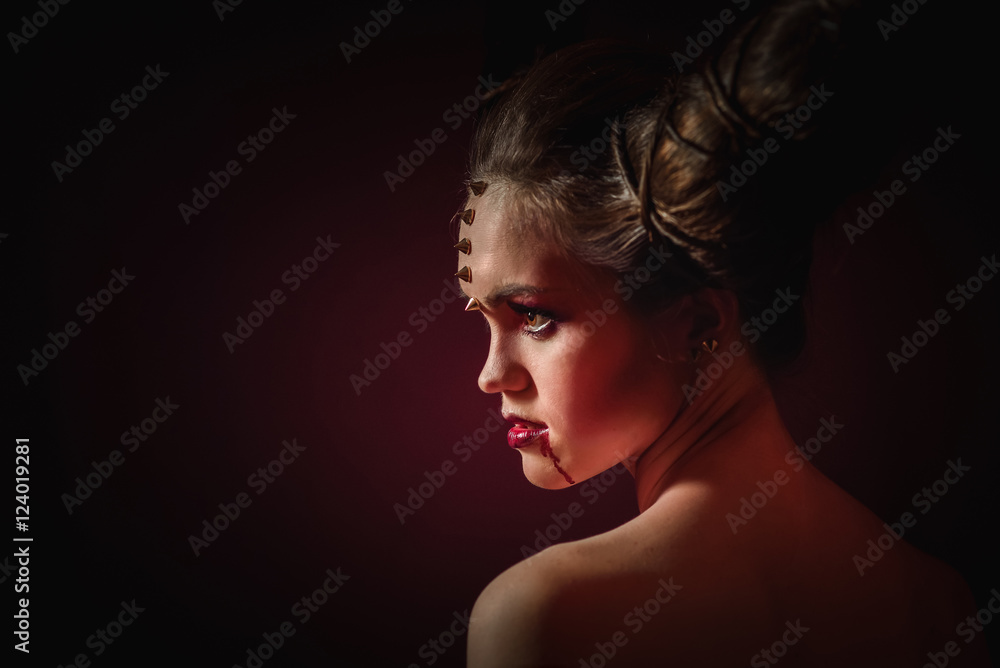 Woman in Halloween makeup with hairstyle in form of horns, Devil Queen Woman in Halloween makeup with hairstyle in form of horns, Devil Queen
