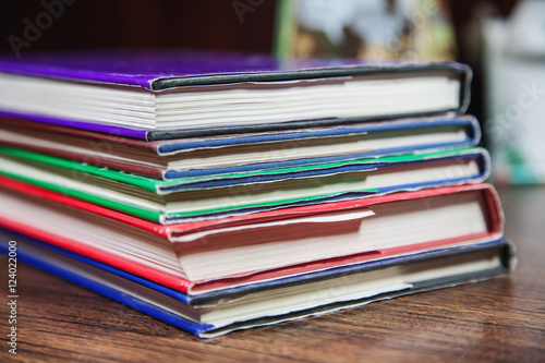 Colored books on wooden table