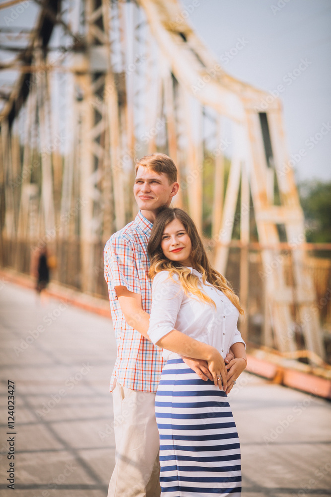 couple kissing each other on a bridge over the river. concept about passion and love couple kissing each other on a bridge over the river. concept about passion and love