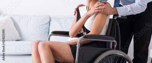 Man supporting his disabled wife
