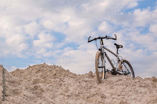 Fototapeta Naklejka Na Ścianę i Meble -  Bike stands on a sand dune.