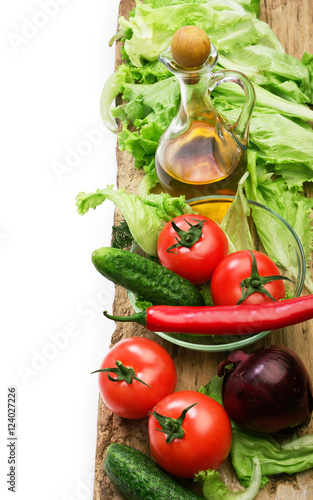 vegetable and jug of vegetable oil isolated on the white backgro