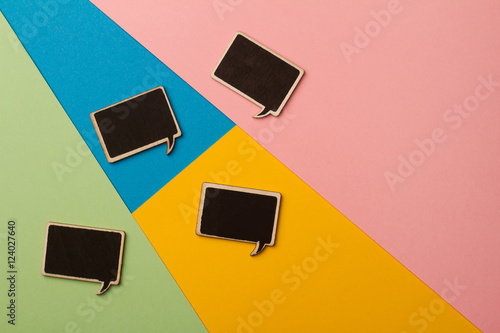 Square empty chalk board speech bubbles on colored papers