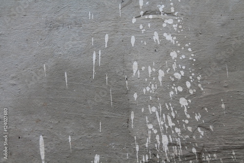Concrete grey wall with splashes of white paing